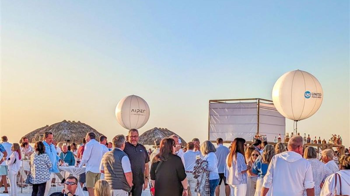 A group of people outside at the United Aqua Group Event