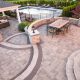 Old Castle APG - picture shows a landscaped backyard with outdoor living area featuring pavers.